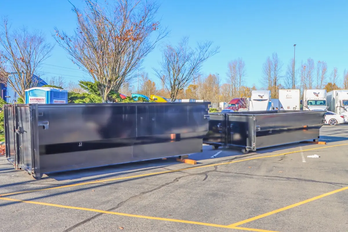 Professional dumpster rental service with roll-off container on residential driveway in Elko New Market